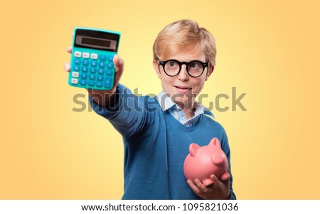 young blonde boy with a piggy bank and calculator