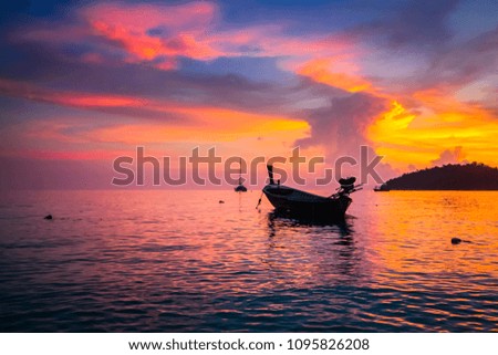 Beautiful twilight sky sweet purple and blue color over the sea have motion blur soft wave with mountain and ship on lipe beach thailand for Silhouette nature background.Low light film grain tone.