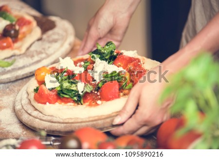 Person serving a homemade pizza
