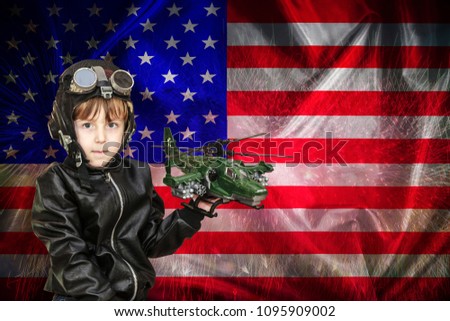 HAPPY INDEPENDENCE DAY, banner, american patriotic background. American Boy in the helmet of the pilot, in the hands of a toy helicopter, copy space.