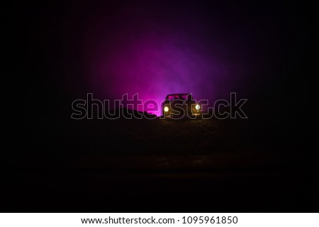 silhouette of car with couple inside on dark background with lights and smoke. Crime car at night. Selective focus