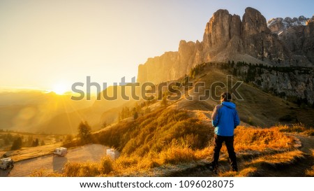 Man traveler hiking alone in breathtaking landscape of Dolomites Mounatins at sunrise in summer in Italy. Travel Lifestyle wanderlust adventure concept. Outdoor wilderness vacations. Royalty-Free Stock Photo #1096028075