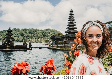 
Young female tourist at the Ulun Danu Batur temple in Indonesia, on the island of Bali. Spiritual and well-known place. Lifestyle, travel photography.