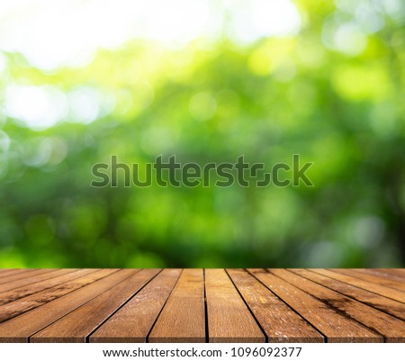 Wood paneling and green bokeh background ,green bokeh abstract of fresh leaves of natural green are available for display or food products. Royalty-Free Stock Photo #1096092377