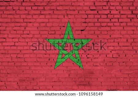 Morocco flag is painted onto an old brick wall