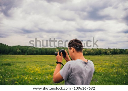 Nature photographer taking photos on the field