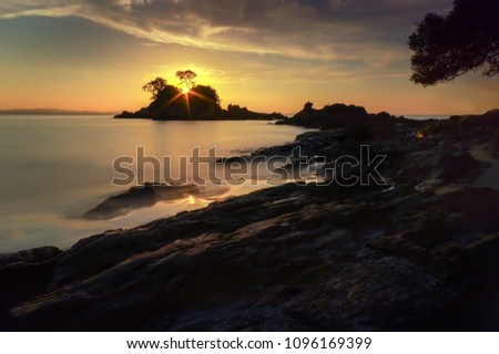 Tropical rocky beach at sunrise ( long exposure photography), Soft effect due to long exposure shot. located at Kapas Island , Terengganu, Malaysia.
soft and grain effect.