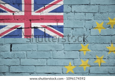 Tuvalu flag is painted onto an old brick wall