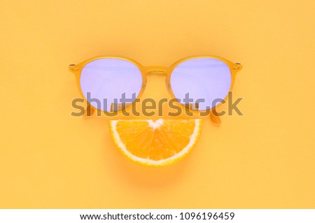 Slice orange and yellow sunglasses set as smiling face on yellow background for Minimal summer. Royalty-Free Stock Photo #1096196459