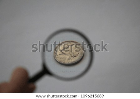 search dollar coin through the magnifying glass