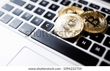 Laptop computer with Bitcoin coin, cryptocurrency concept