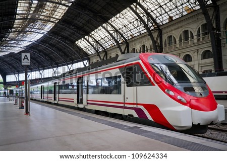 Modern train at the station. Barcelona, Spain. Royalty-Free Stock Photo #109624334