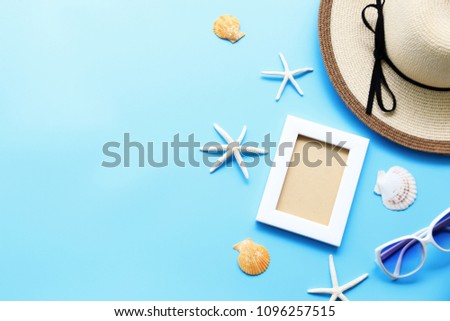 Beach hat and picture frame with starfish,Shell on blue table In the summer Asia,copy space,Top view,minimal style