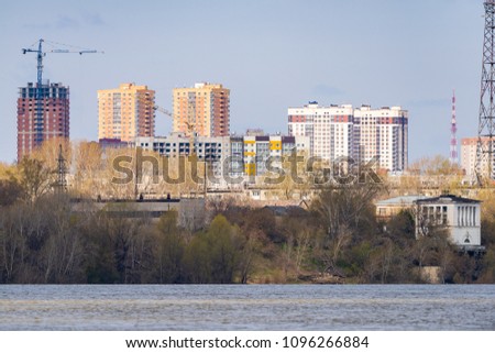 Cityscape. High-rise buildings on the river bank in a clear sunny day.
