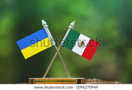Mexico and Ukraine small flag with blur green background