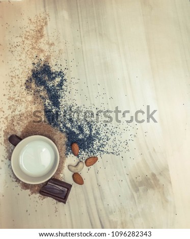  sugar and poppy with cookies and cup of milk on a wooden board