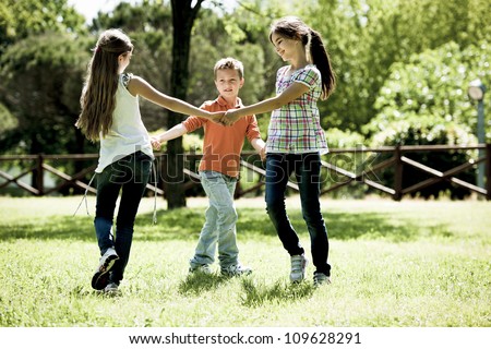 Small group of children playing ring-around-the-rosy Royalty-Free Stock Photo #109628291