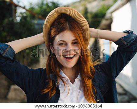 happy woman in blue blouse and hat