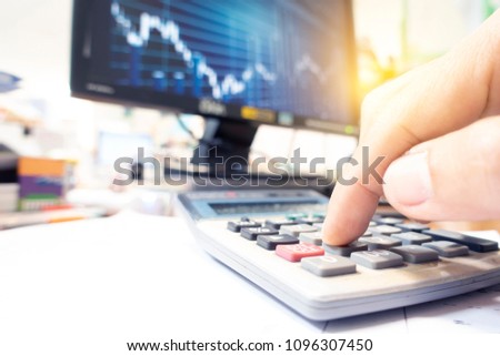 Business concept with people calculation with stock market trading.