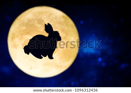 Easter bunny silhouette over a full moon