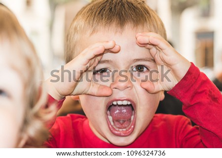 Child with hands on eyes to observe