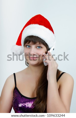 attractive girl in a Christmas hat talking on a cell phone