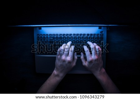 Russian hacker hacking the server in the dark Royalty-Free Stock Photo #1096343279