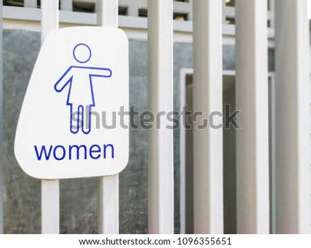 Female toilet sign on wooden wall.