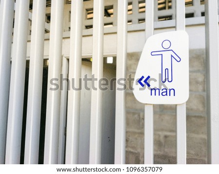 Male toilet sign on wooden wall.