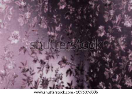 purple satin fabric with traditional printed flowers in the blur