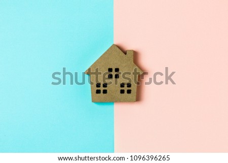 brown wood home icon on blue and pink background