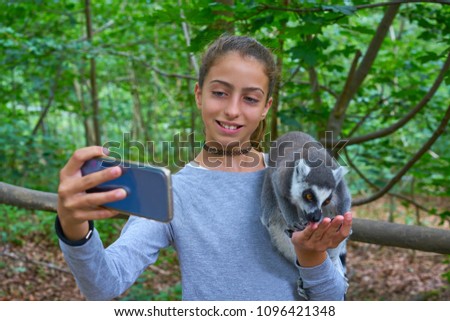 Kid girl having fun with ring tailed lemurs selfie photo animals outdoor