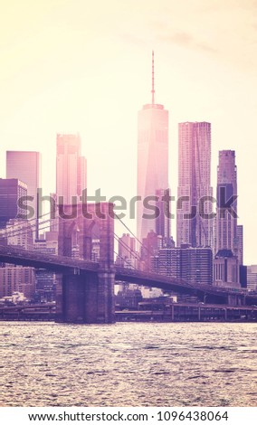 Retro toned picture of Manhattan skyline at sunset, New York City, USA.