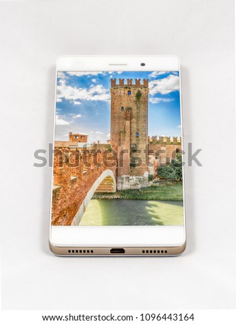 Modern smartphone with full screen picture of Castelvecchio Bridge, Verona, Italy. Concept for travel smartphone photography. All images in this composition are separately available on my portfolio