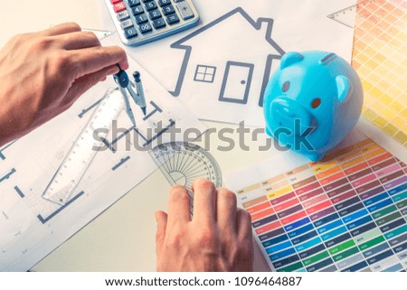 Architect drawing plan of house with colors chart and light