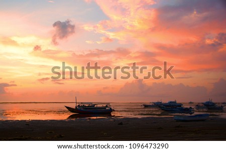 Bright dawn on the shore of the ocean at low tide