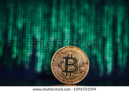 Gold bitcoin with geen code on black background. Electronic currency, internet finance, ?rypto currency concept. Worldwide famous currency, bitcoin mining.