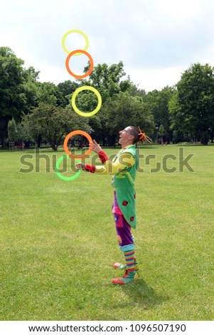 Circus juggler portrait. Clown juggling with objects.