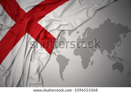 waving colorful national flag of england on a gray world map background.