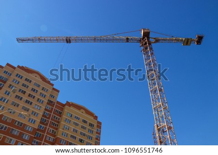 construction crane against the blue sky. building

