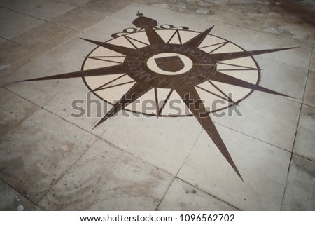 The Compass Rose, symbol of the Anglican Communion. The center of the Compass Rose contains the cross of St. George and is surrounded by the inscription in Greek "The truth shall set you free." 