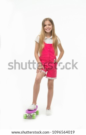 Sport activity and energy. Small girl smile with skate board isolated on white. Child skater smiling with longboard. Skateboard kid in pink jumpsuit. Childhood games. Her favorite mode of transport.