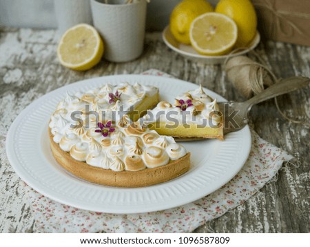 Rustic composition with lemon curd Tart decorated with lightly burned meringue. Slice of the pie. ?lose up. 