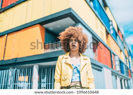Mixed race woman in a multicolor houses background