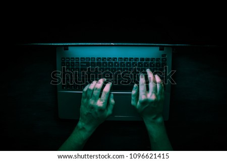 Russian hacker hacking the server in the dark Royalty-Free Stock Photo #1096621415