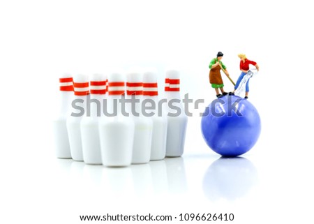 Miniature people : Maid or Housewife cleaning bowling pin and ball.
