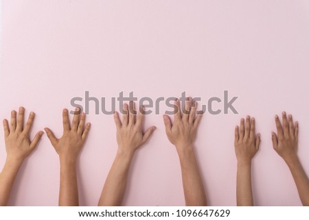 Six hank put on pink wall.