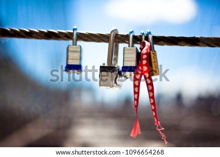 four key locks hanging on a metal wire