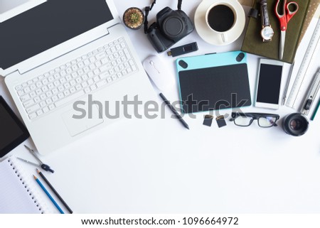 White desk office with laptop, smartphone and other work supplies with cup of coffee. Top view with copy space for input the text. Designer workspace on desk table essential elements on flat lay.
