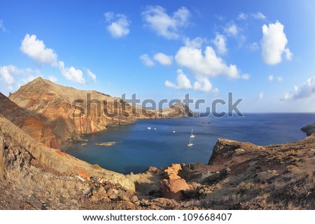 Madeira. Picturesque white boat in a rocky bay on the east of the island